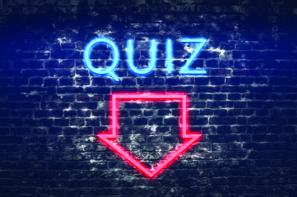 quiz neon sign on dark brick wall background
